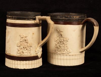 Appraisal: Two English white stoneware tankards decorated hunting scenes trees etc