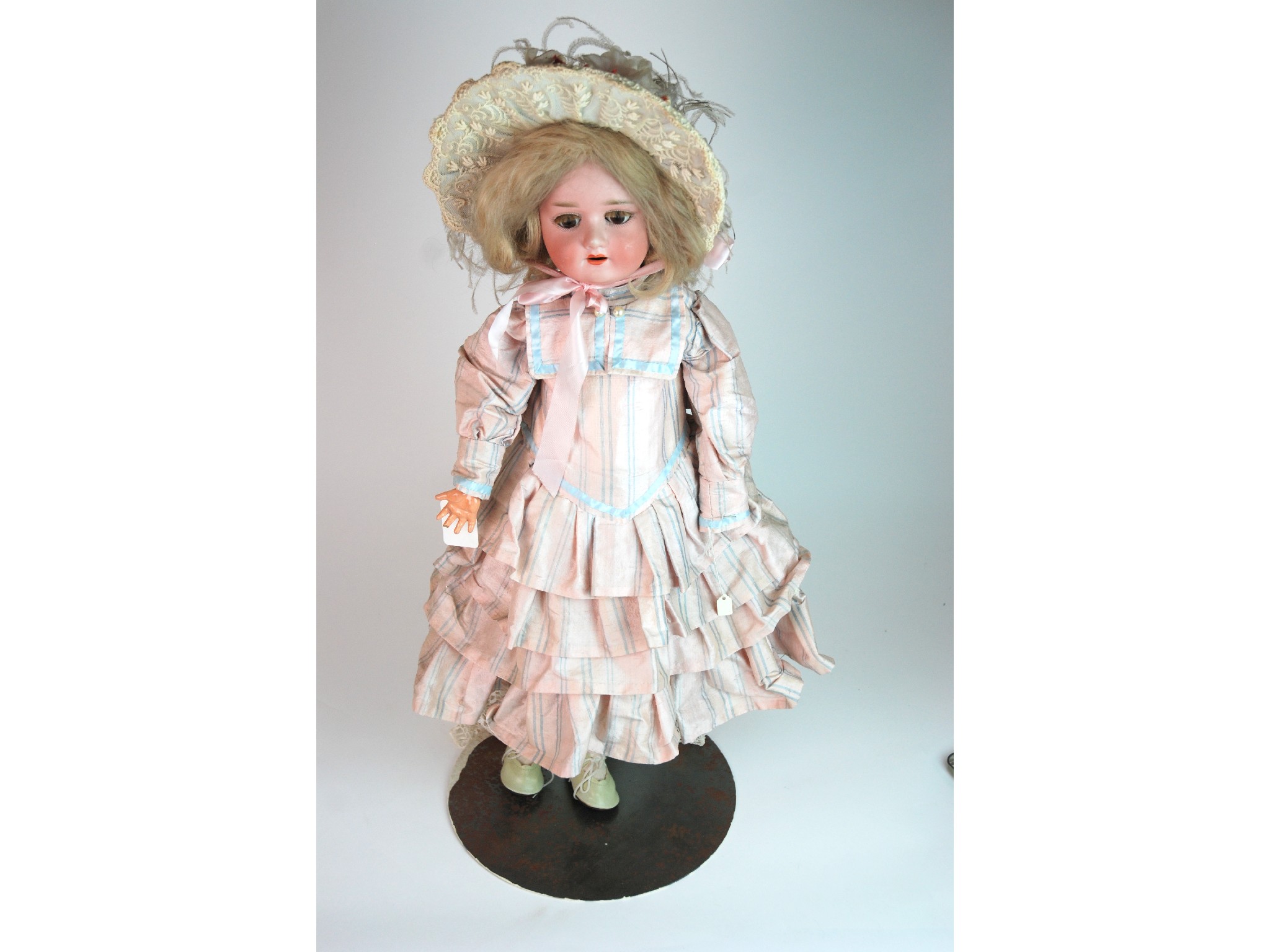 Appraisal: A Schoenau and Hoffmeister bisque-headed dollwith open and close brown