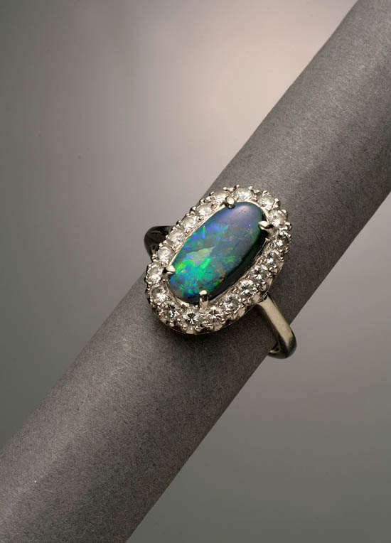 Appraisal: -Karat White-Gold Black Opal and Diamond Dinner Ring The four-prong