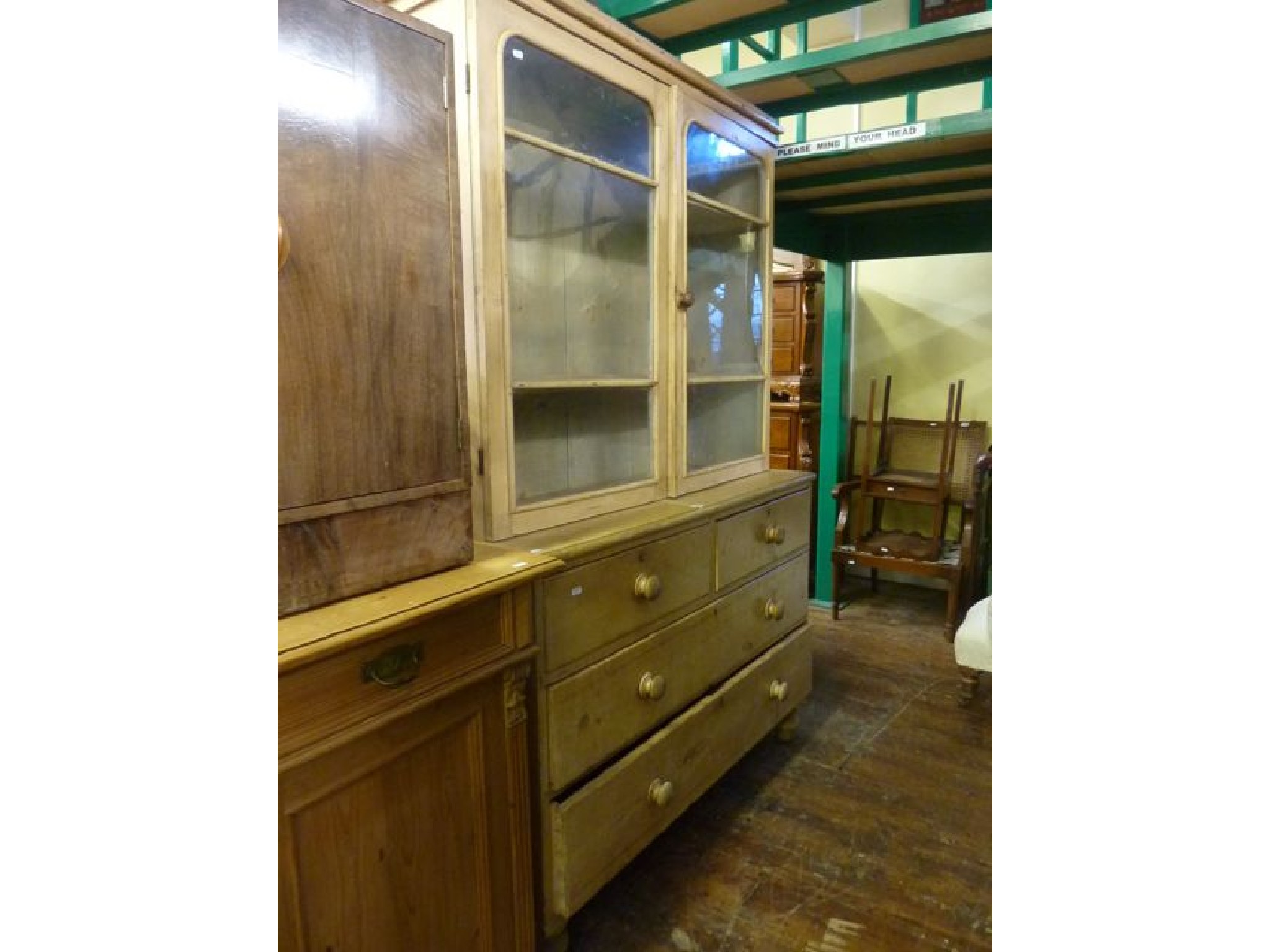 Appraisal: A mid th century stripped and waxed pine side cupboard