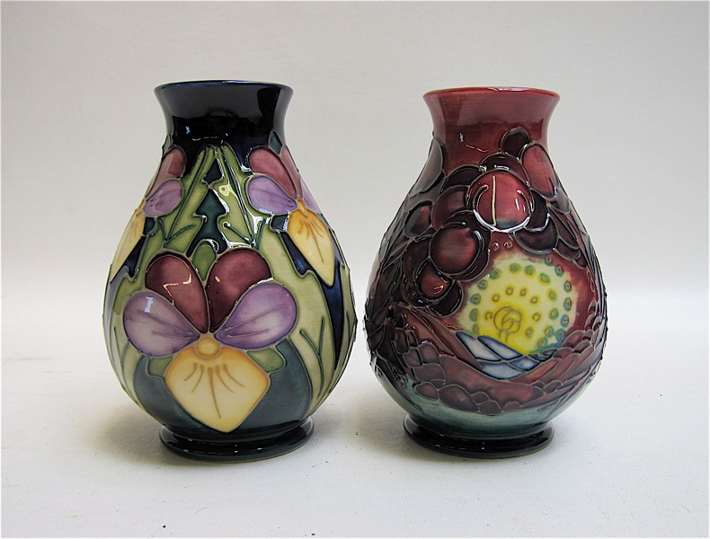 Appraisal: TWO MOORCROFT POTTERY VASES each hand painted under glaze one