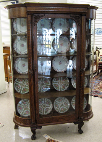 Appraisal: CARVED AND CURVED GLASS CHINA CABINET American late th century