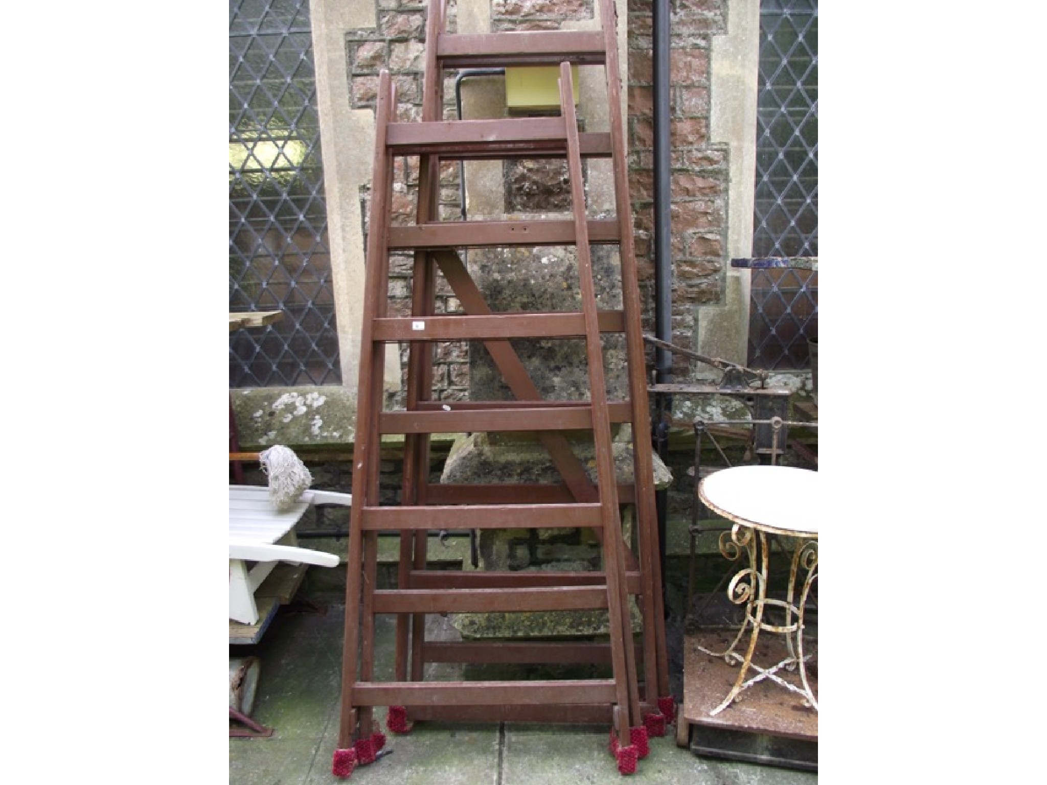 Appraisal: Two large similar stained wooden A framed folding trestles