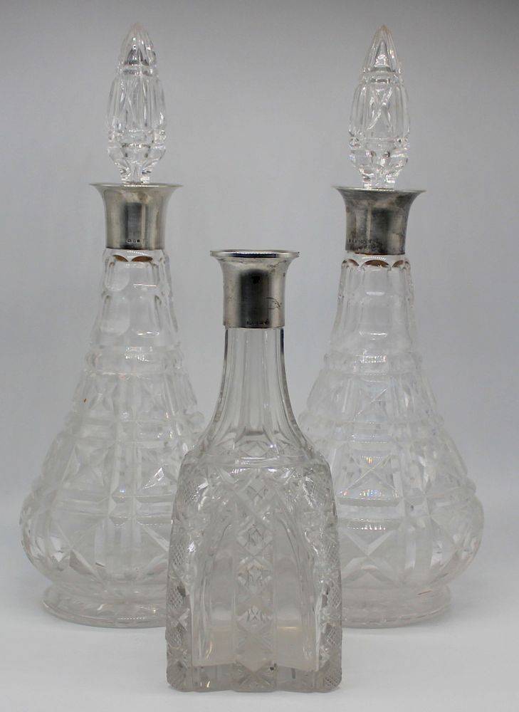 Appraisal: SILVER Pair of English Silver Mounted Decanters Includes a pair