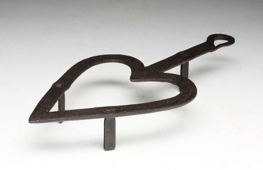 Appraisal: AMERICAN WROUGHT IRON HEART TRIVET Three plain riveted feet Age