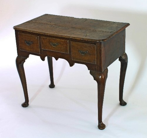 Appraisal: A George II burr oak lowboy the top with re-entrant