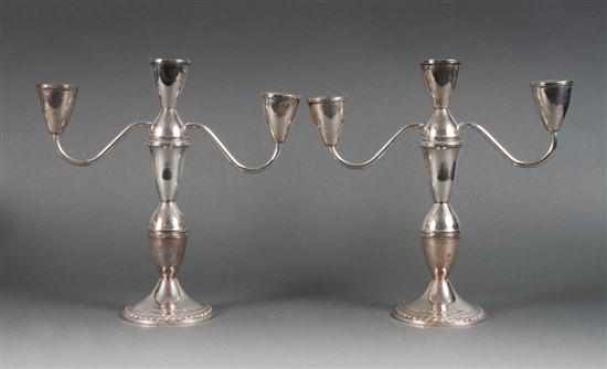 Appraisal: Pair of American weighted sterling silver three-light candelabra Duchin in