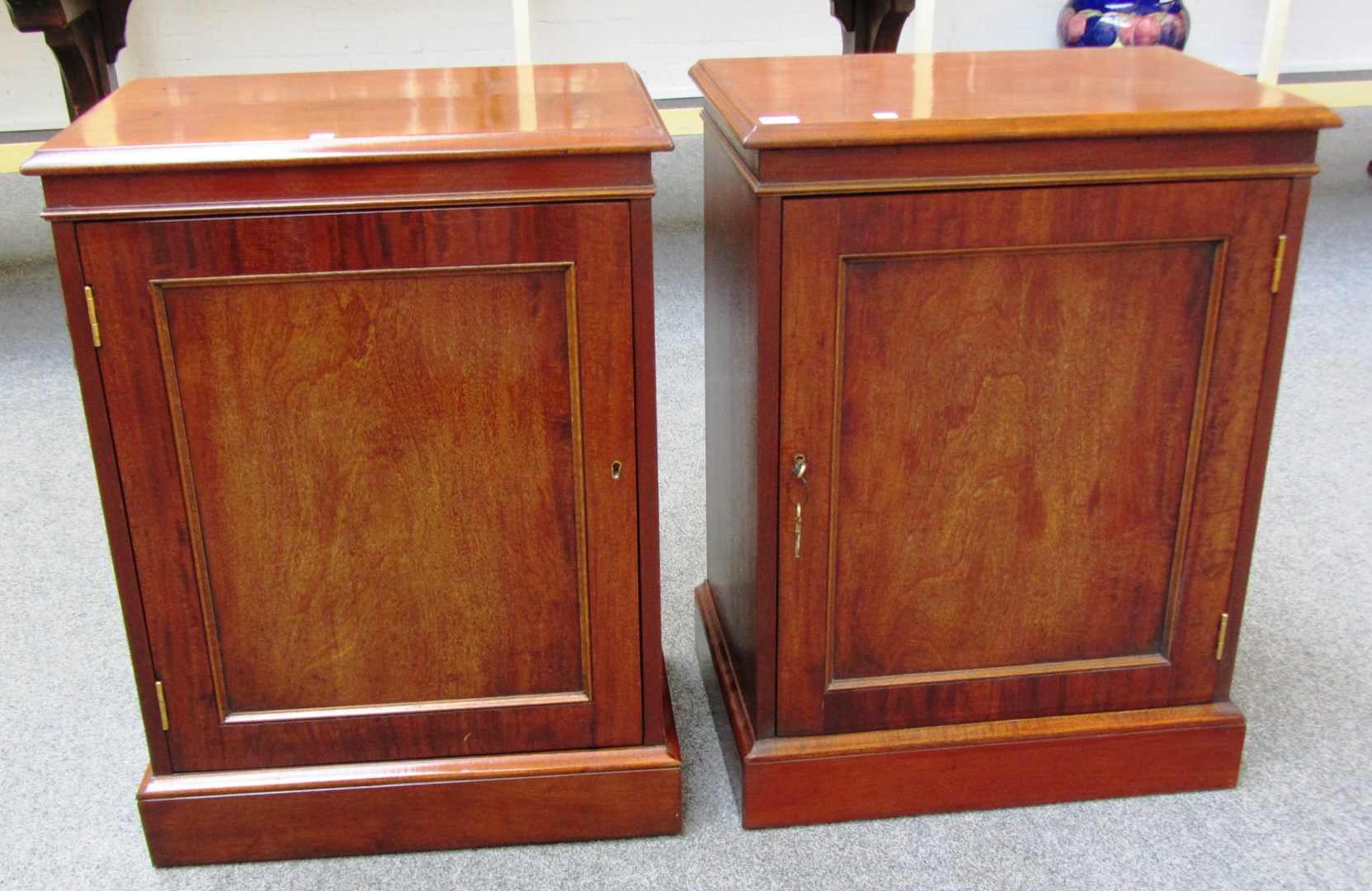 Appraisal: A pair of mahogany pedestal cupboards on plinth bases cm