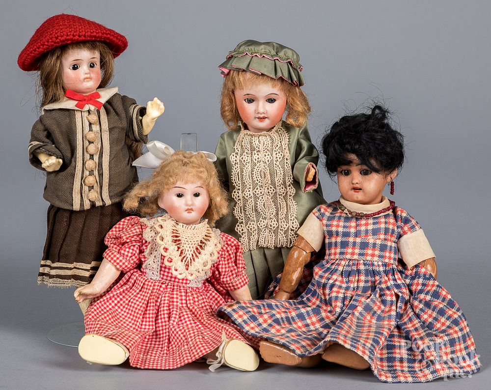 Appraisal: Four small bisque head dolls Four small bisque head dolls