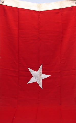 Appraisal: Red cotton flag with applied star Flag measures x grometted