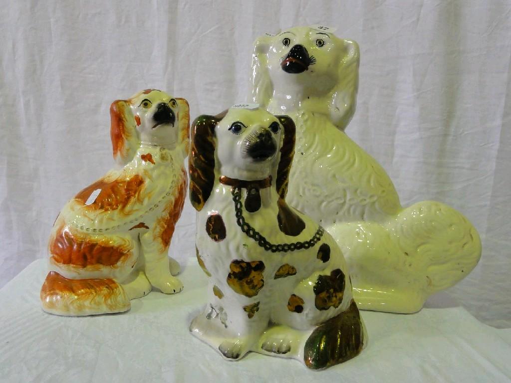 Appraisal: Three th century Staffordshire spaniels one with copper lustre patches