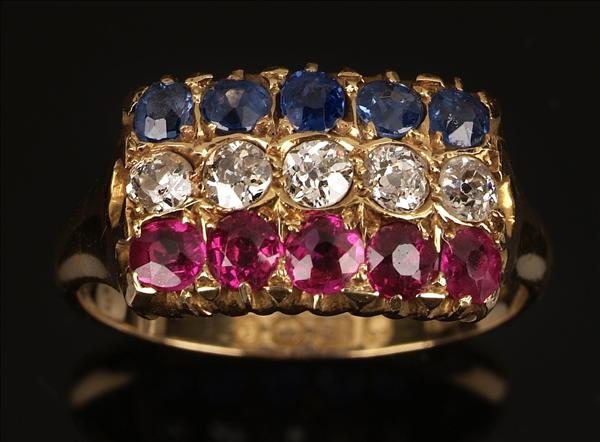 Appraisal: An Edwardian ruby sapphire and diamond triple row ring claw