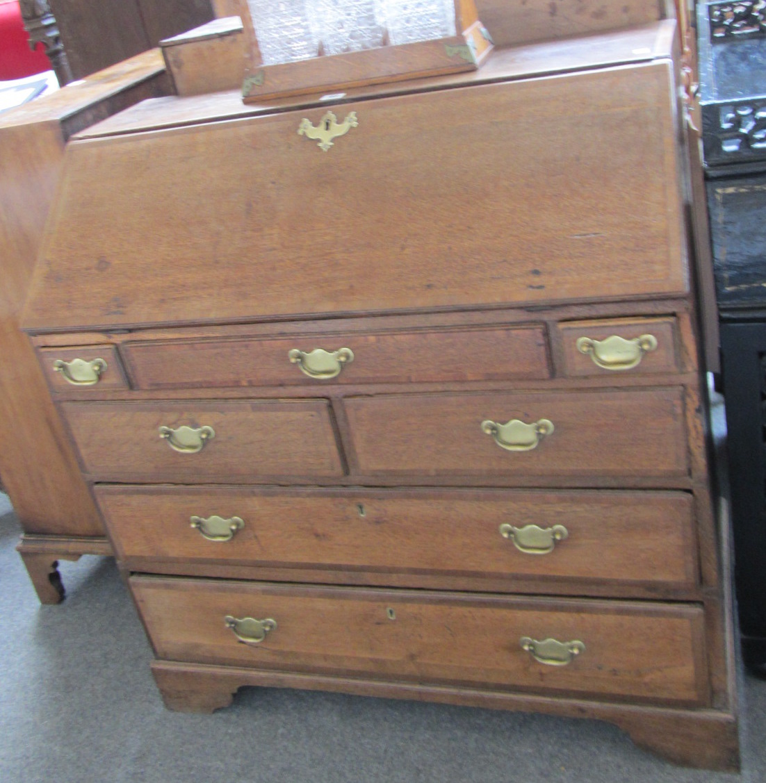 Appraisal: An th century mahogany banded oak bureau the fall over