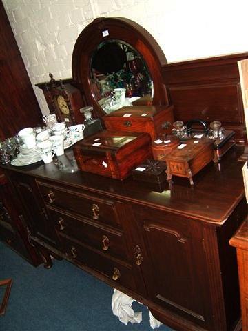 Appraisal: An Edwardian mahogany sideboard with raised mirrored back and four