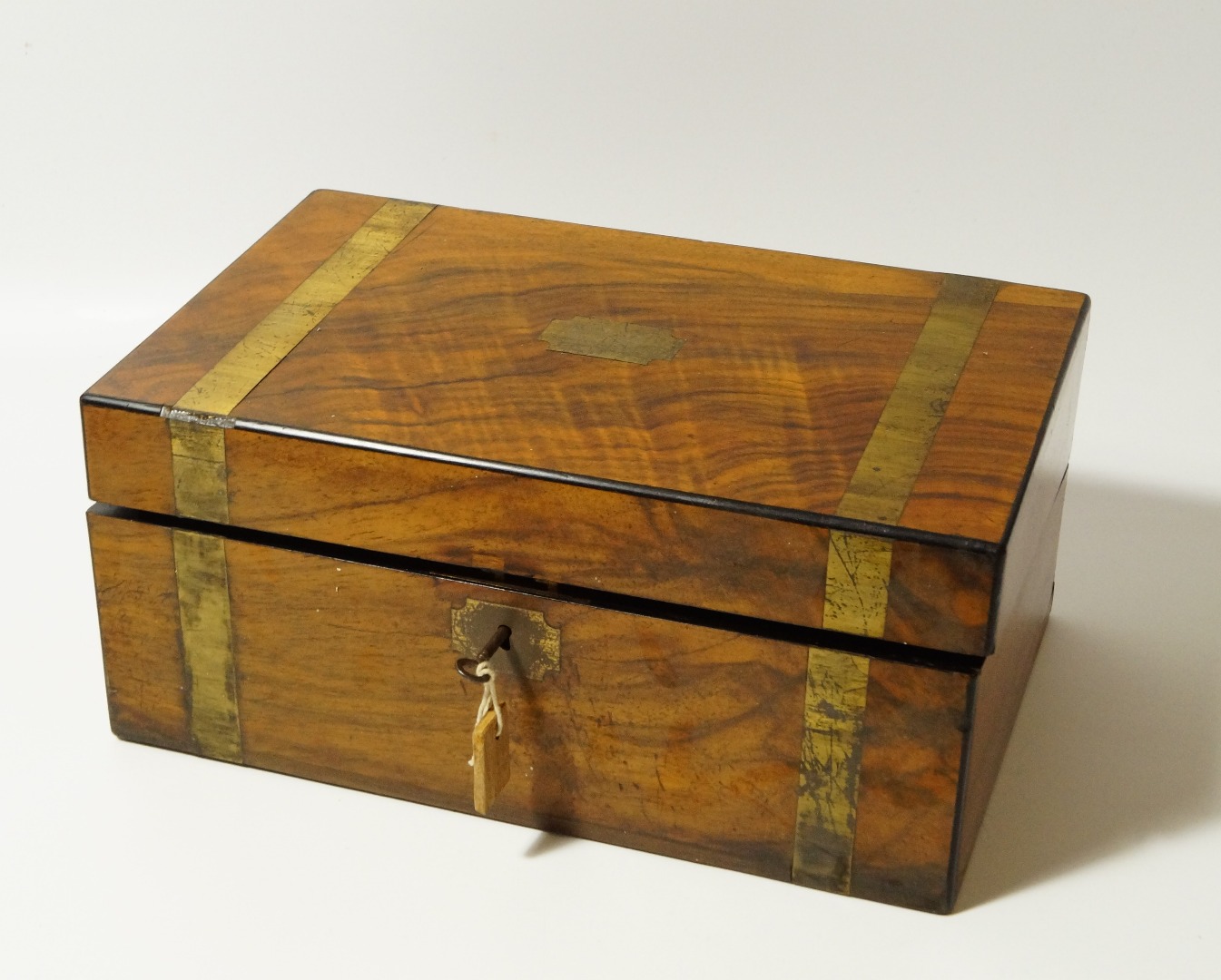 Appraisal: A burr walnut rectangular box with campaign brasswork cm wide