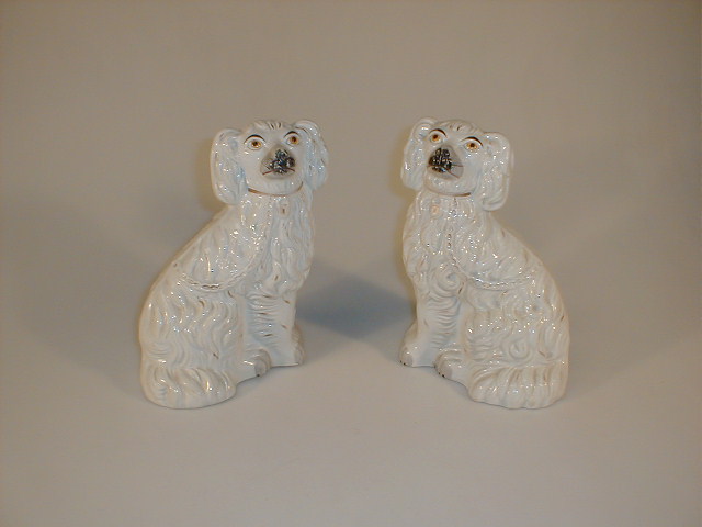 Appraisal: A pair of thC Staffordshire seated spaniels each with amber