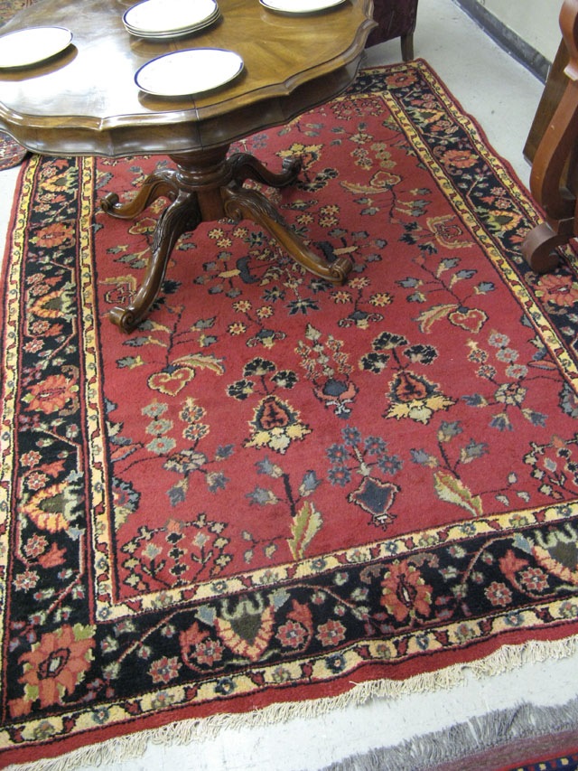 Appraisal: ORIENTAL INDO-SAROUK CARPET having a floral sprig decorated red field