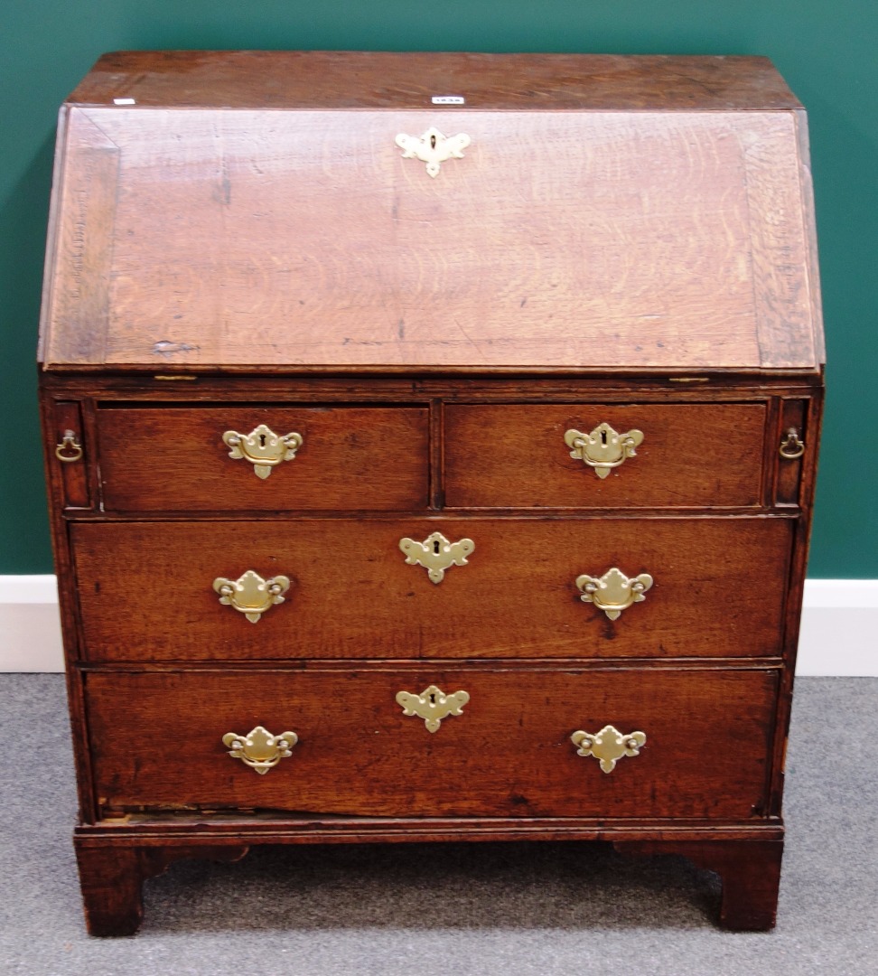 Appraisal: A small th century oak bureau the fitted interior over