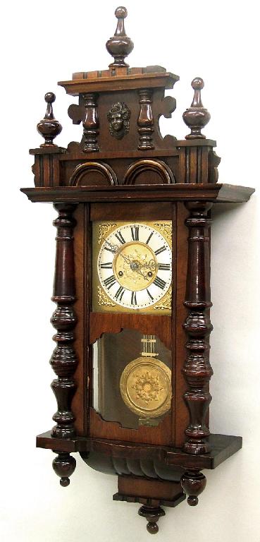 Appraisal: German walnut and stained beech two train wall clock by