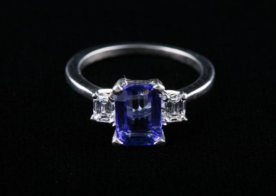 Appraisal: PLATINUM TANZANITE AND DIAMOND RING ct emerald-cut tanzanite centered by