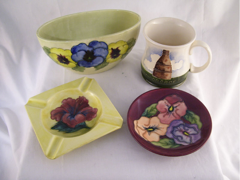 Appraisal: pc Moorcroft Lot Lot includes Moorcroft factory mug measures high