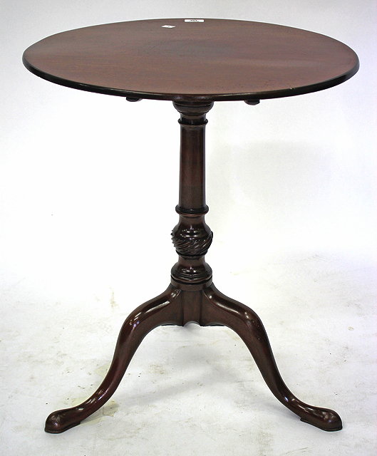 Appraisal: A MAHOGANY CIRCULAR TILT TOP TRIPOD TABLE on turned column