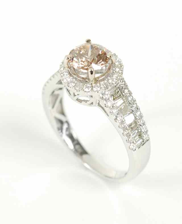 Appraisal: DIAMOND AND FOURTEEN KARAT WHITE GOLD RING round-cut and baguette-cut