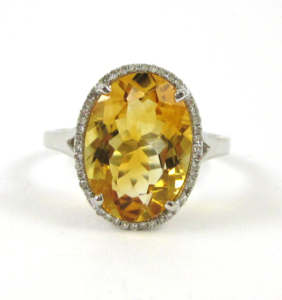 Appraisal: FOURTEEN KARAT WHITE GOLD CITRINE AND DIAMOND RING oval mixed-cut