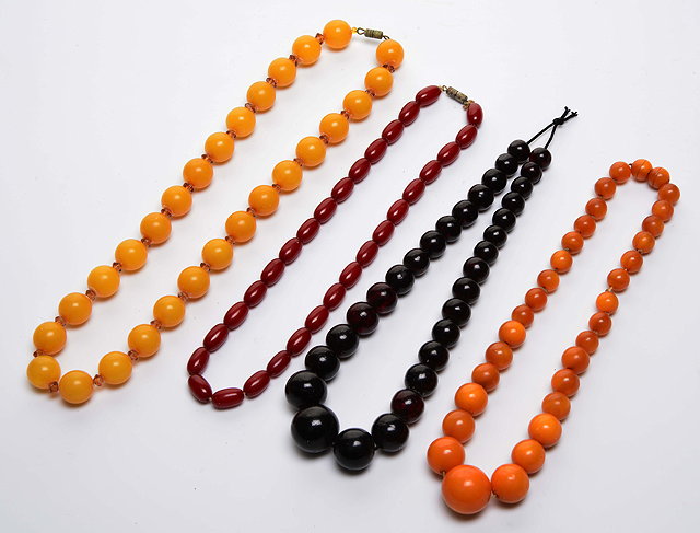 Appraisal: THREE FAUX AMBER BEAD NECKLACES