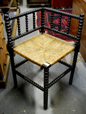 Appraisal: Victorian ebonised bobbin turned corner chair with rush seat the