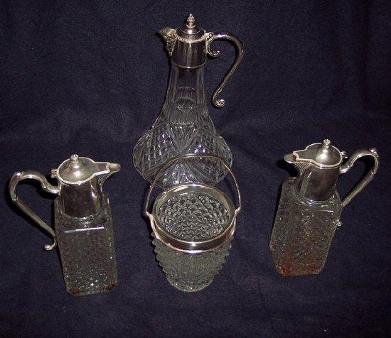 Appraisal: A cut glass claret jug with plated hinged cover scroll