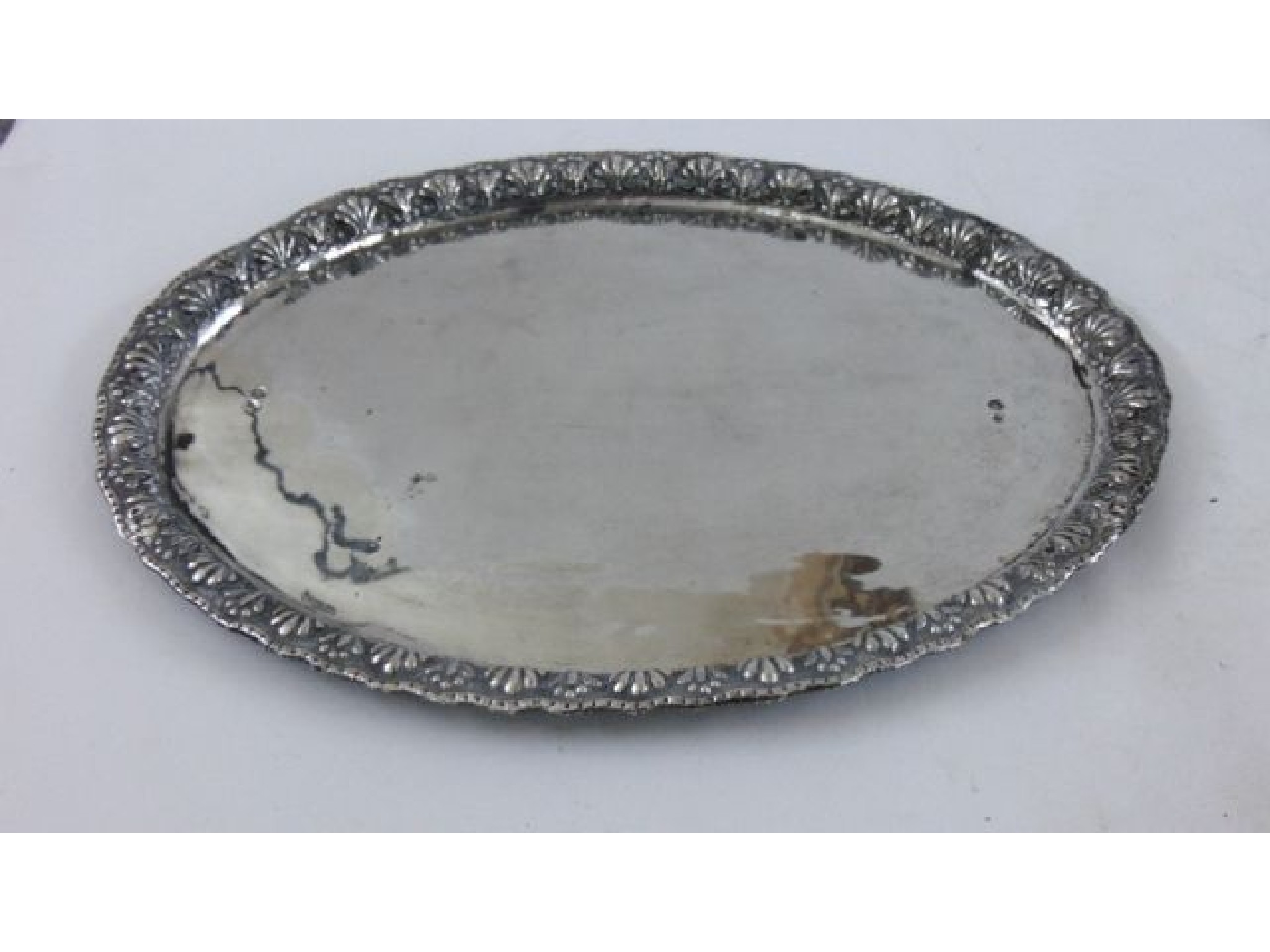 Appraisal: An Eastern white metal tray oval with raised and decorated