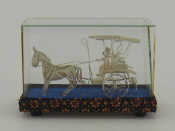 Appraisal: A white metal filigree model horse and two wheeled dos-a-dos