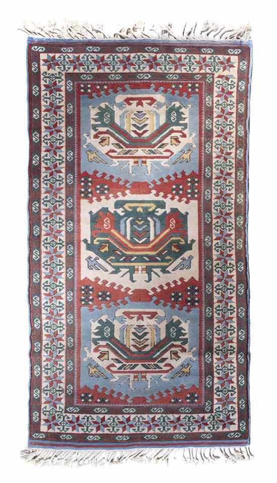 Appraisal: A Northwest Persian Wool Rug having three stylized geometric motifs