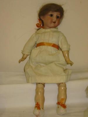 Appraisal: An Armand Marseille bisque head walking girl doll with brown