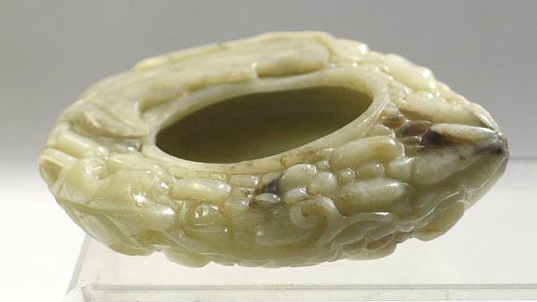 Appraisal: A grey-green jade brushwasher Of irregular shape carved with four