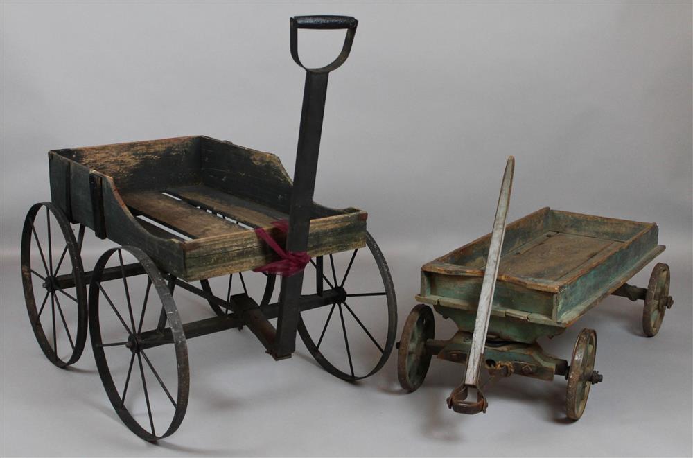 Appraisal: TWO WOODEN WAGONS WITH METAL WHEELS AND REMNANTS OF GREEN