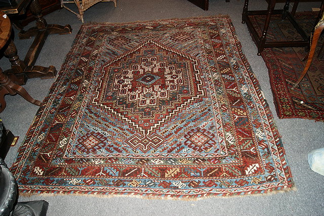 Appraisal: A HAMADAN POLYCHROME WOOL RUG with central geometric medallion and