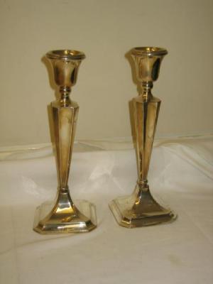 Appraisal: A PAIR OF EDWARDIAN CANDLESTICKS the urn socket on tapered