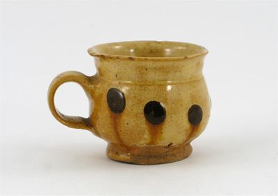 Appraisal: A slipware small thistle-shaped cup decorated with seven brown circular