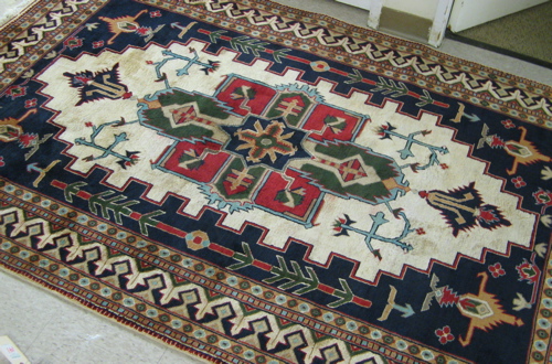 Appraisal: PAKISTANI-PERSIAN AREA RUG central geometric medallion and stylized floral design