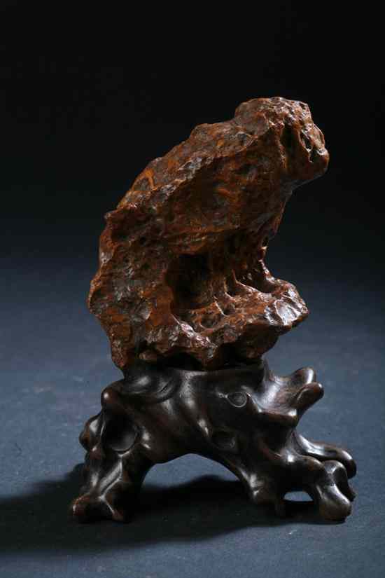 Appraisal: CHINESE SCHOLAR'S ROCK Of reddish brown tone on wood stand