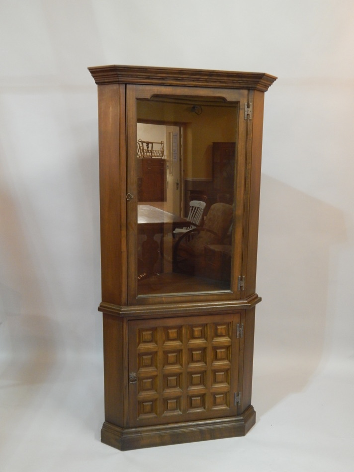 Appraisal: A modern Ercol style oak standing corner cabinet with single