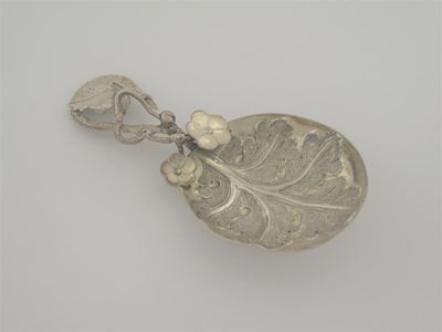 Appraisal: A Victorian silvergilt caddy spoon with a tendril stem applied