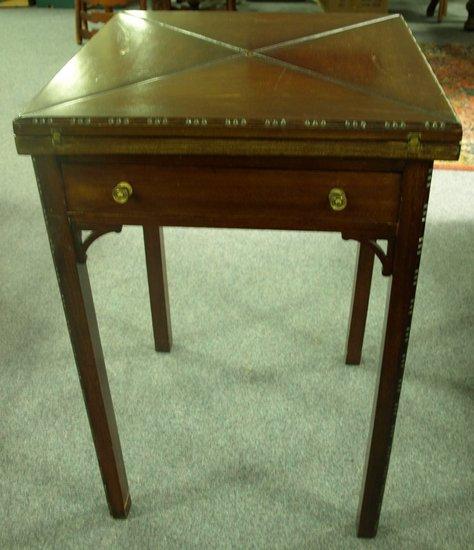 Appraisal: An Edwardian mahogany envelope card table fitted a single drawer