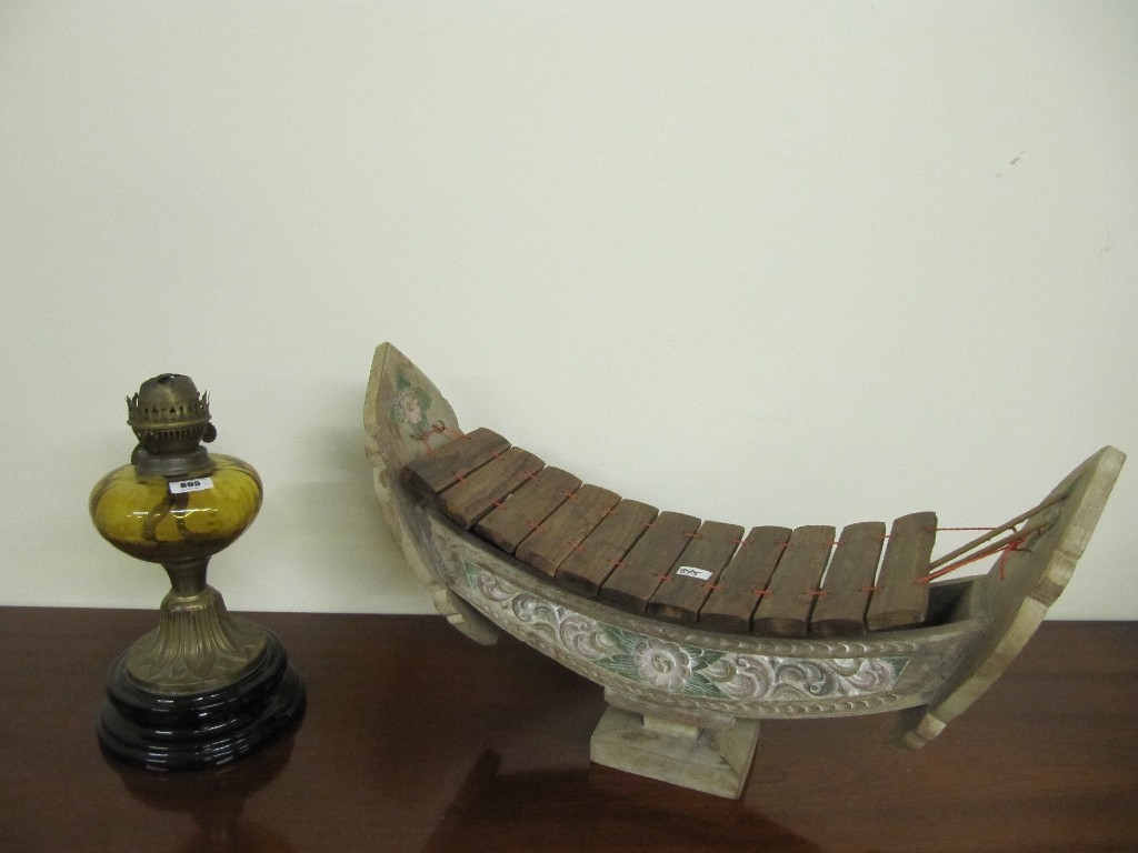 Appraisal: Eastern musical instrument and an oil lamp