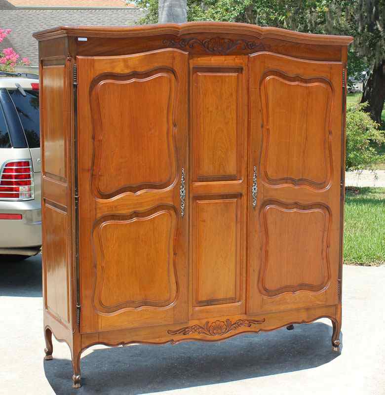 Appraisal: COUNTRY FRENCH WALNUT ARMOIRE Paneled doors and sides slightly arched