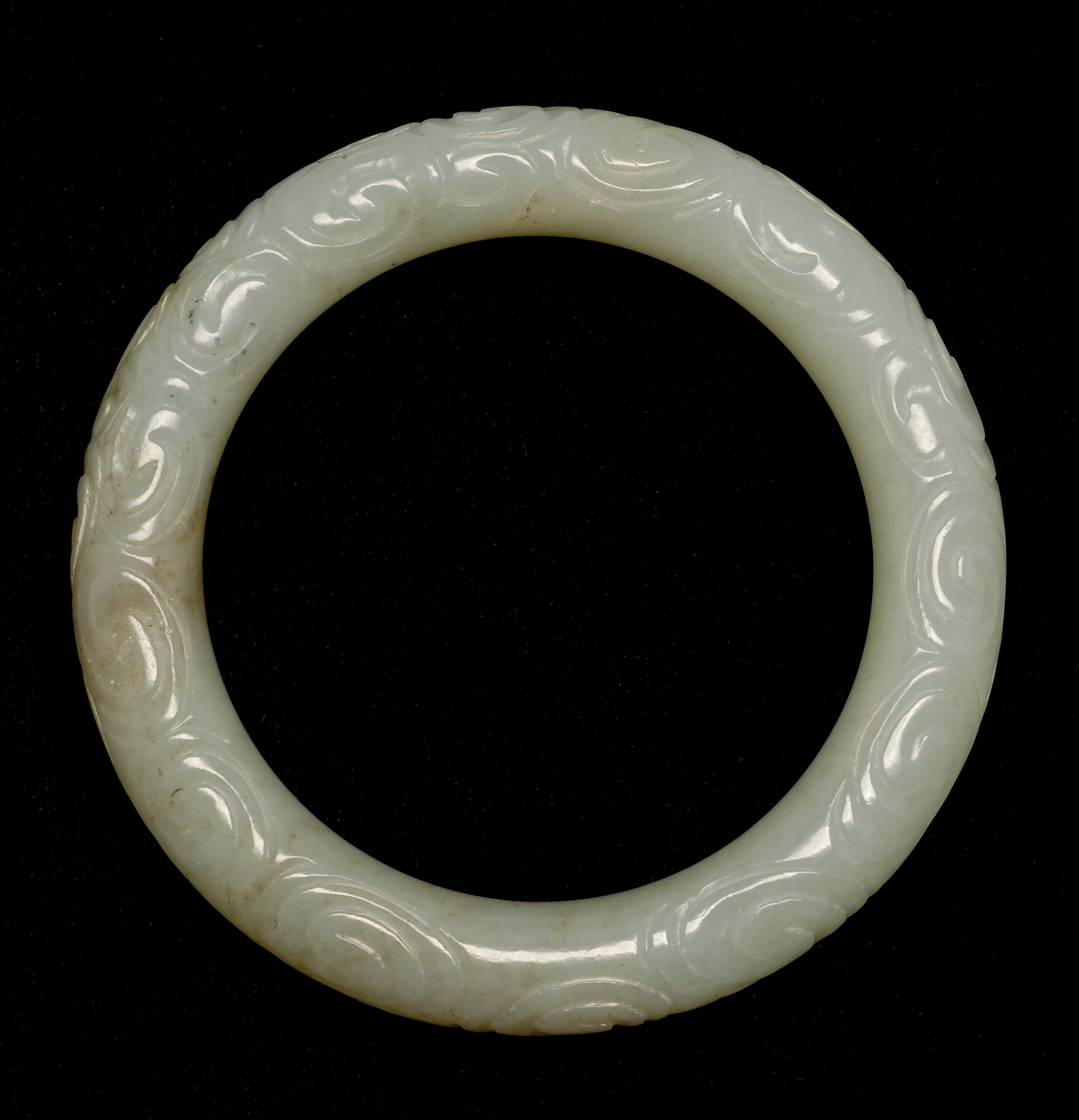 Appraisal: CELADON JADE BANGLE BRACELET th CenturyIn cloud design Exterior diameter