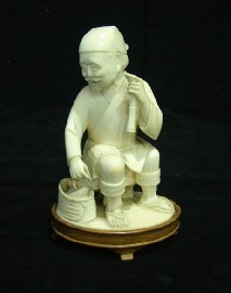 Appraisal: A Chinese figure of a seated fisherman in carved ivory