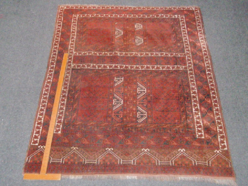 Appraisal: A burgundy ground Bokhara style rug cm x cm